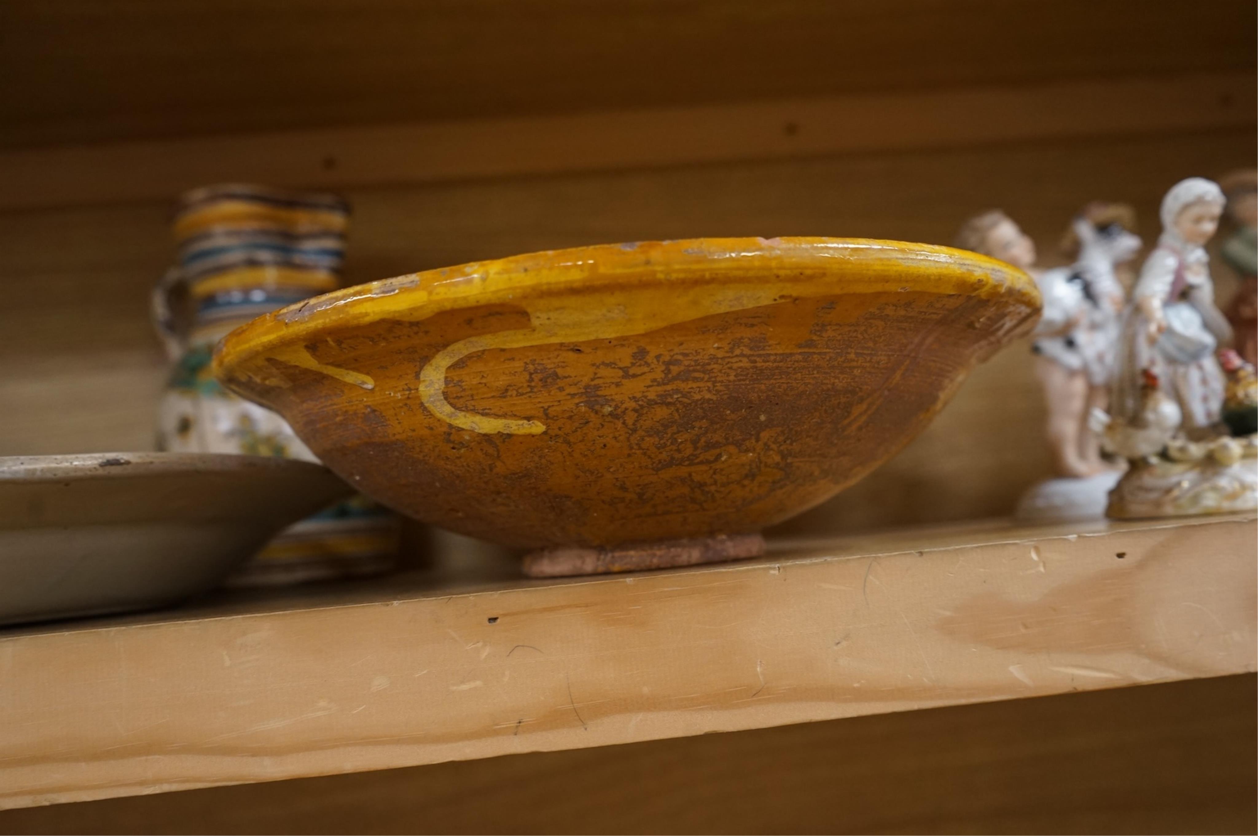 A late 17th century Spanish tin glazed jug together with Moroccan and pottery bowls and dishes (5). Jug 26cm high.